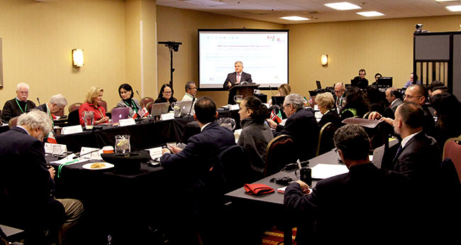 Bob Varney speaking in front of audience at the Tenth Regular Session of the CEC Council