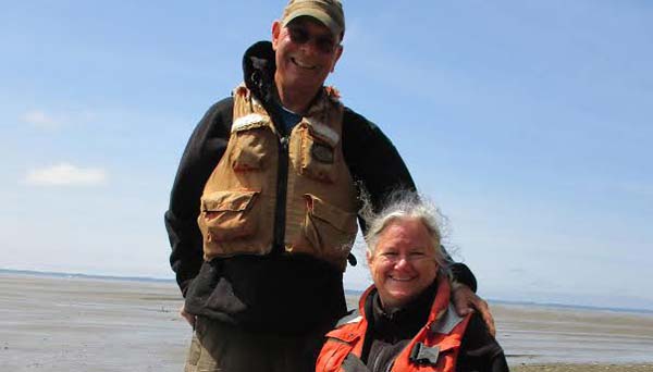 Photo of Janet and Ed Darcher standing at the shore